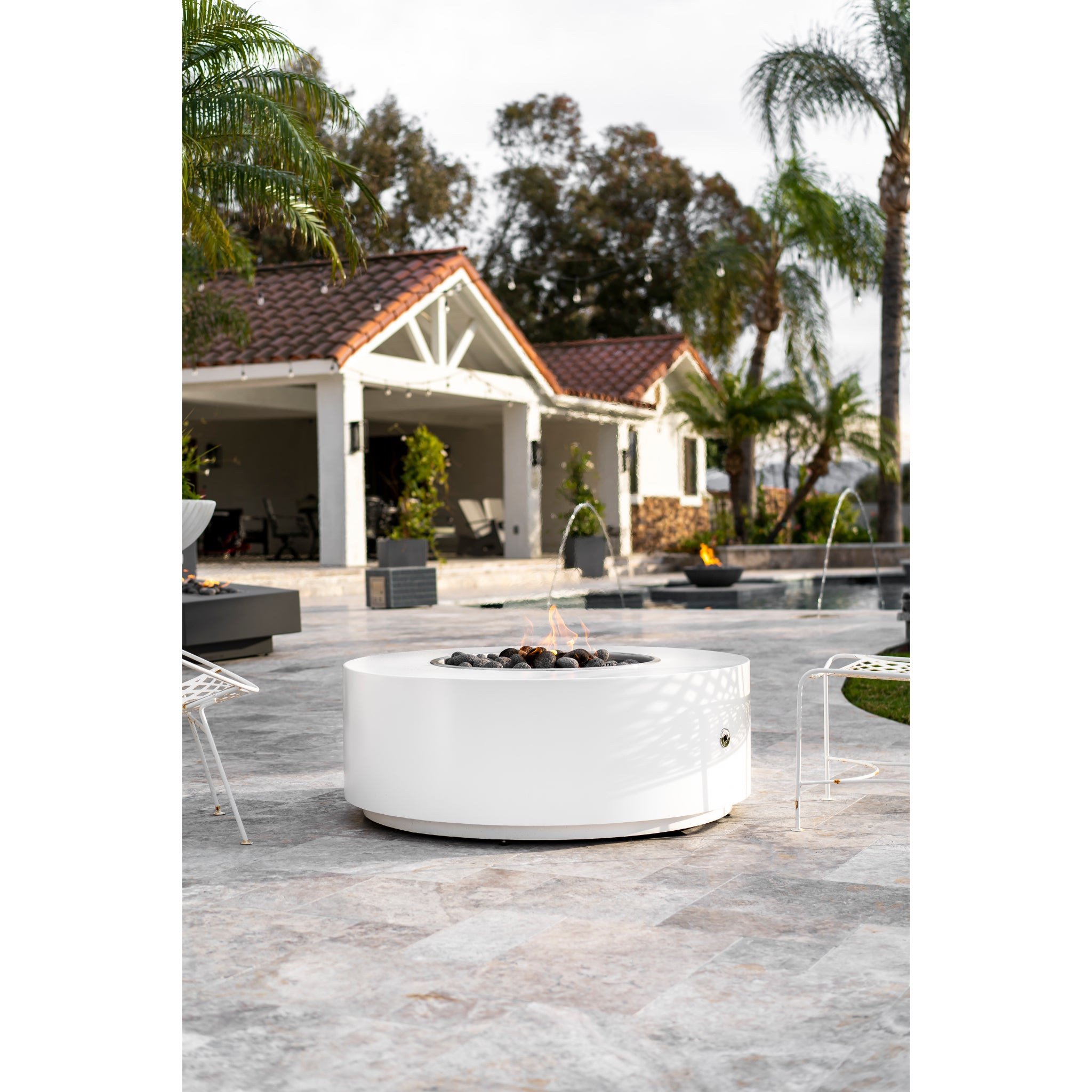 Unity Round Fire Pit in White finish at resort pool