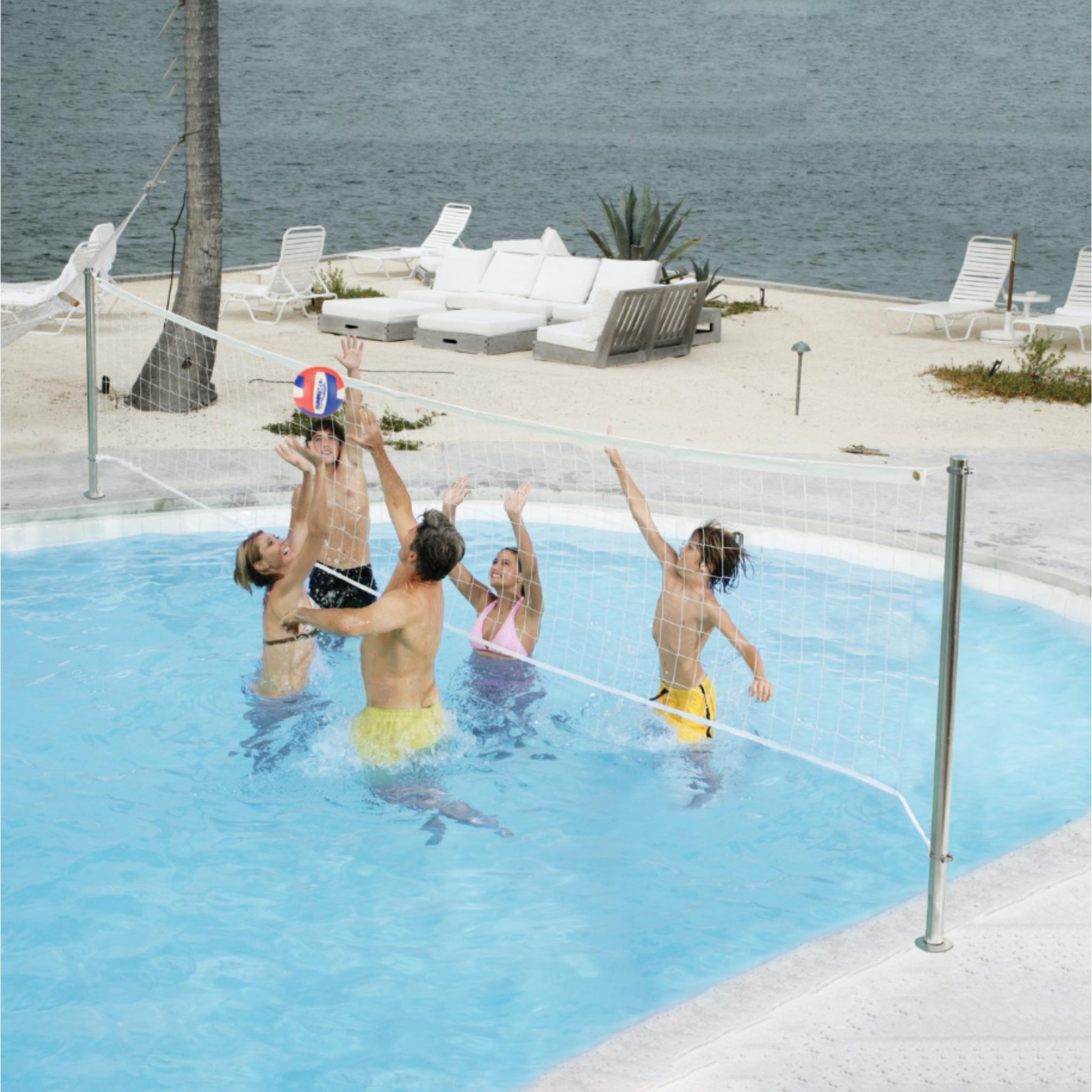 Clear Hoop poolside in-ground Stainless DeckVolley volleyball net combo installed on residential pool deck
