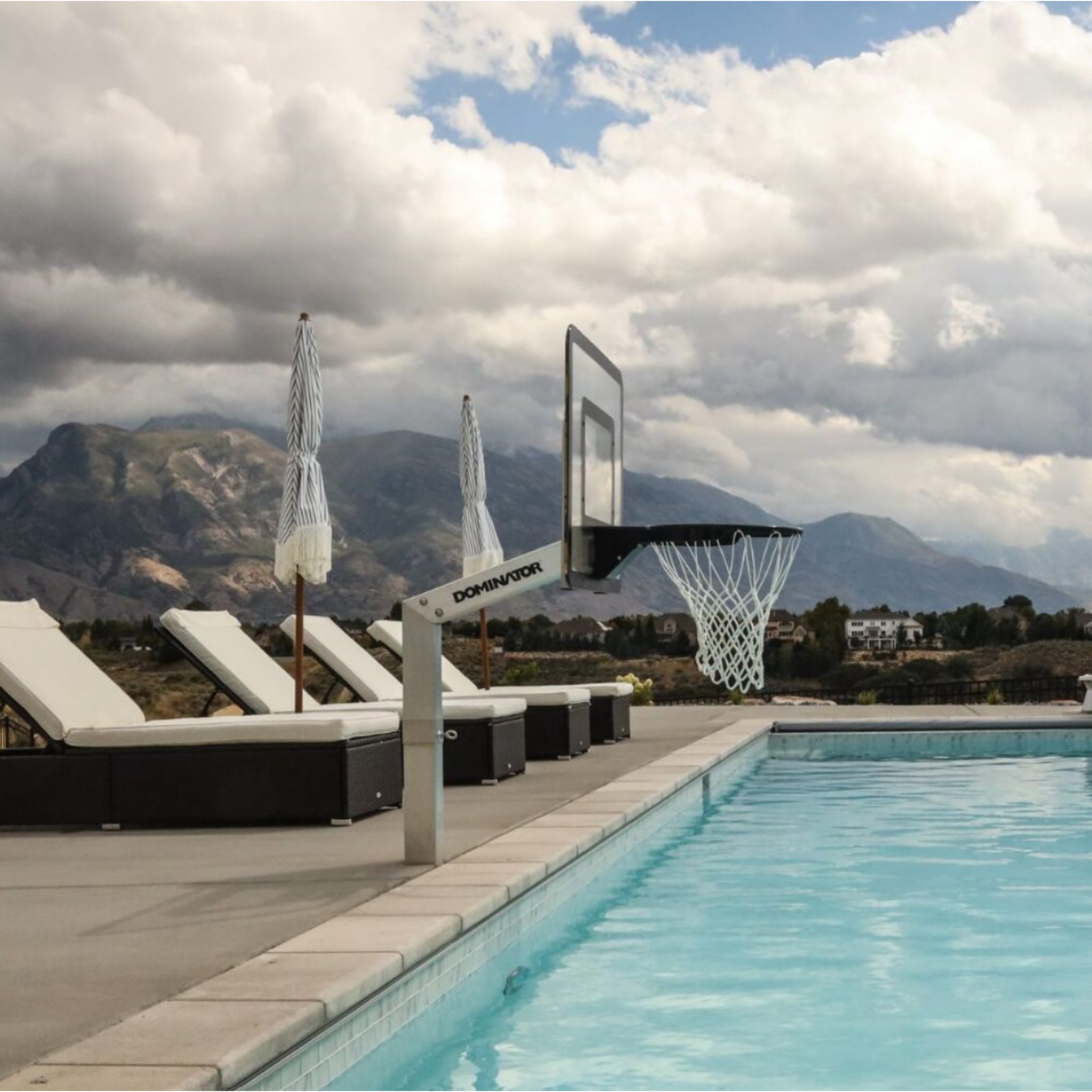 Poolside in-ground basketball hoop installed beside swimming pool with waterproof rim and aluminum frame
