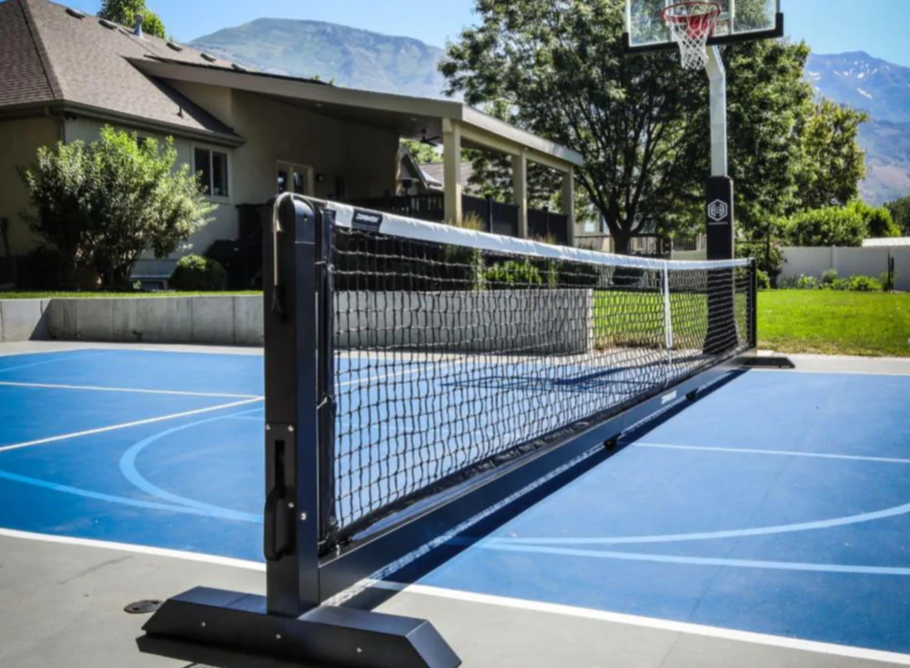 Professional-grade portable pickleball net system on a luxury outdoor court