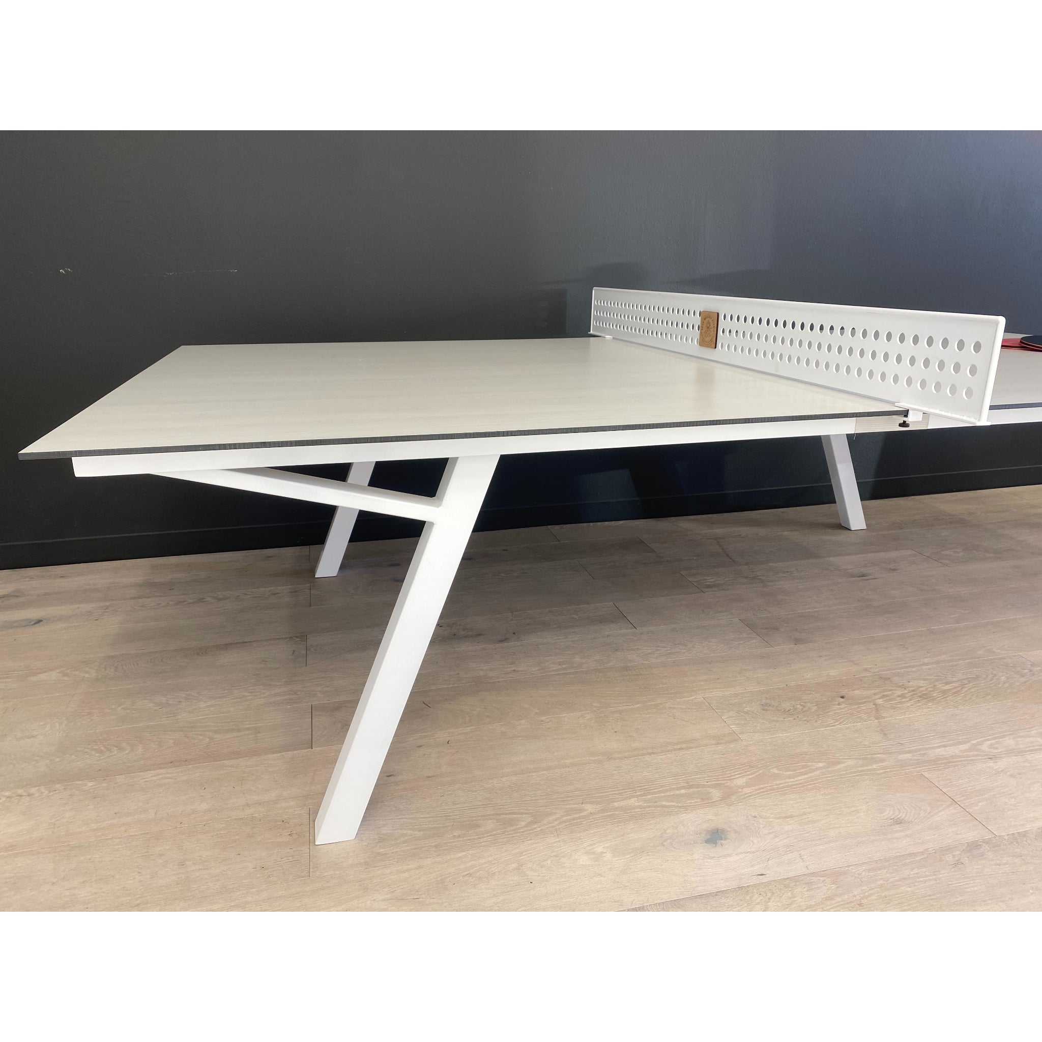 High-end outdoor table tennis table by Sean Woolsey in resort-style setting, perfect for hotels, country clubs, and commercial amenity spaces