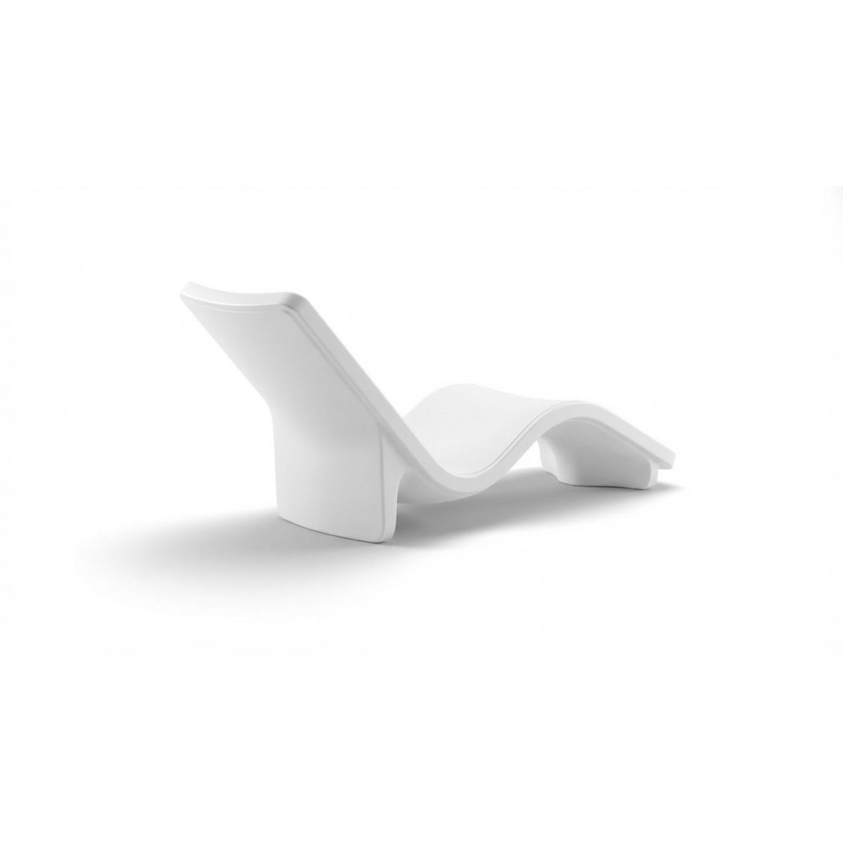 Side and rear angle studio shot of a baja shelf chaise, emphasizing its stacked wave design and smooth Highcloud White finish, SKU 8902-700.