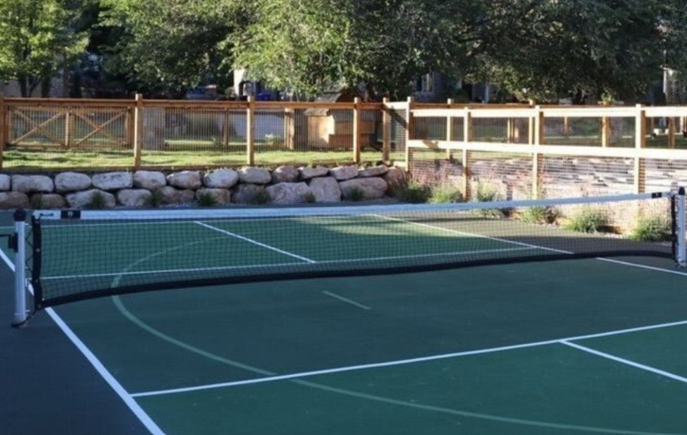 Luxury backyard pickleball court with premium net system and outdoor recreation space