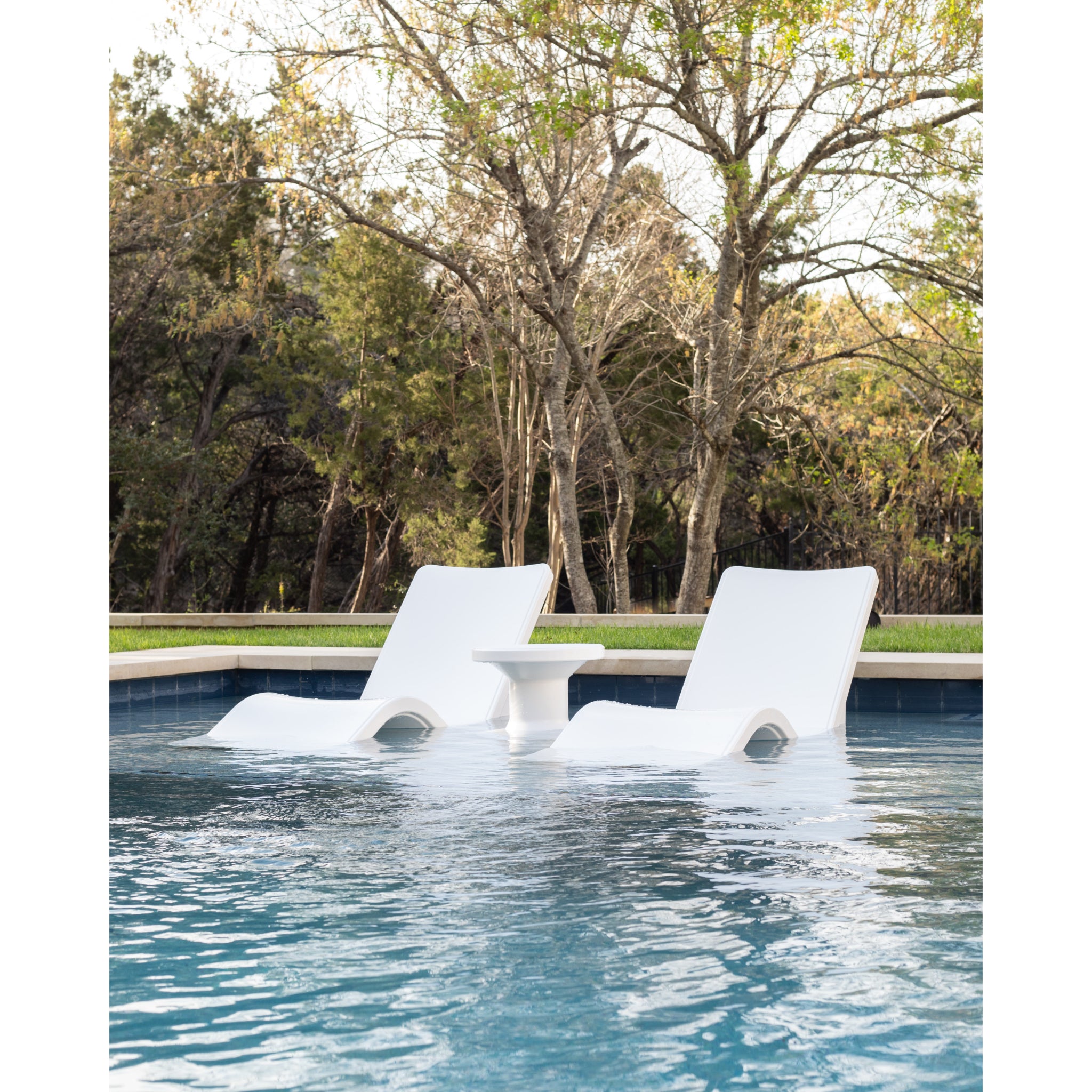 Baja shelf pool lounger in shallow water designed for sun shelf relaxation