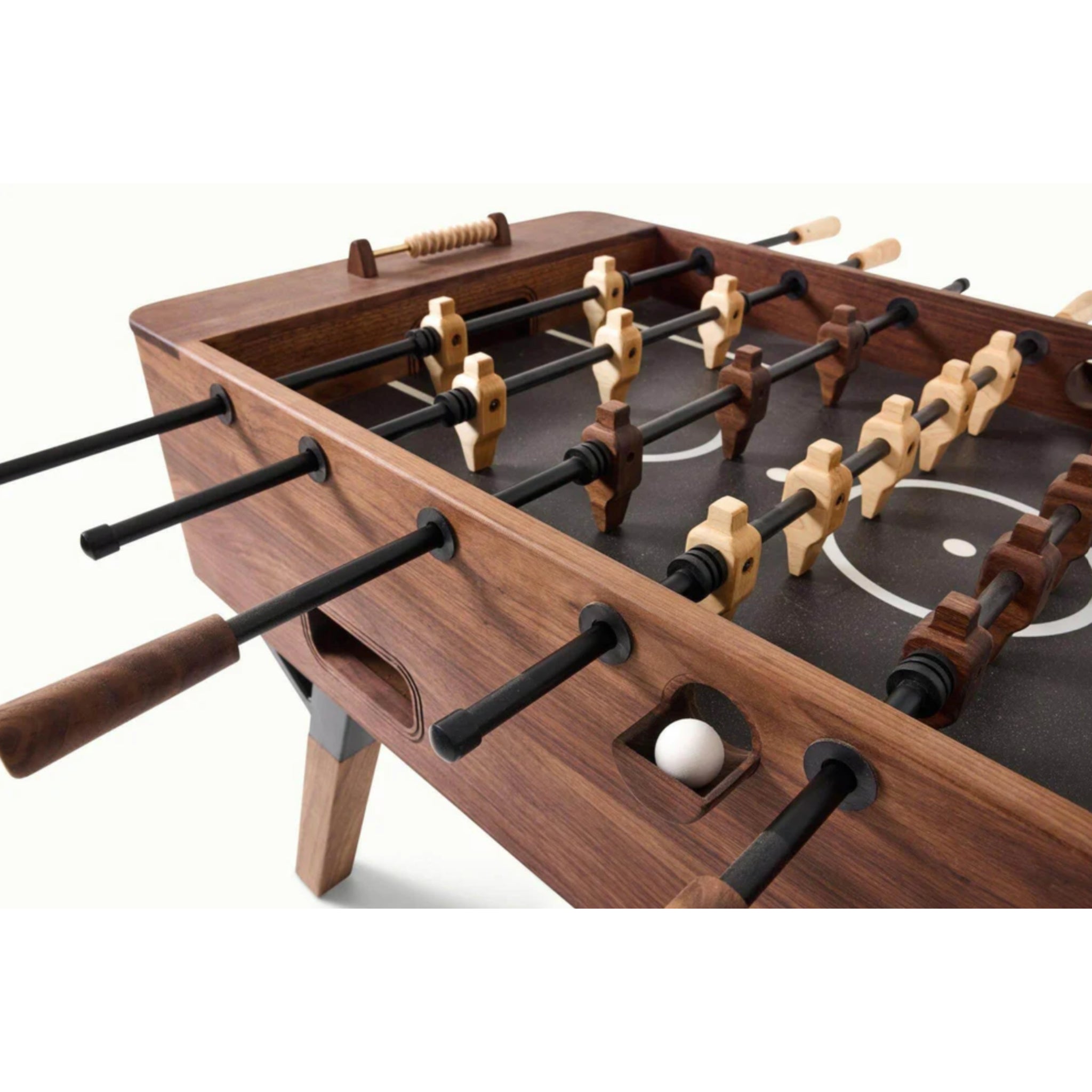 Close view of professional foosball table rods and players on dark playfield
