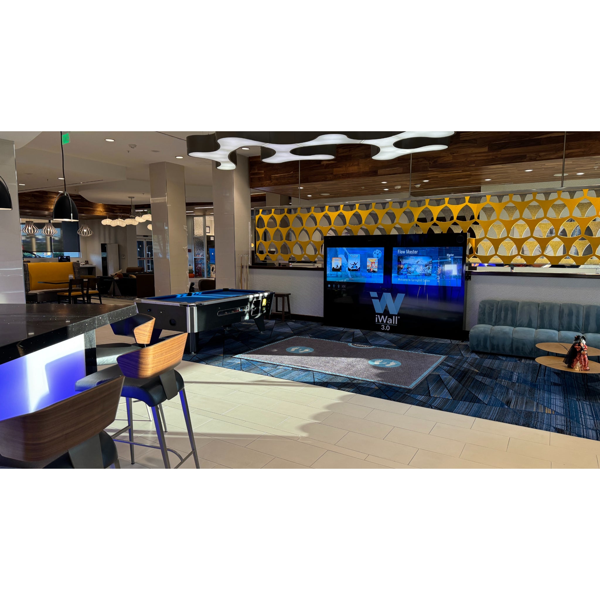 Motion-controlled interactive gaming wall for resorts and family entertainment venues