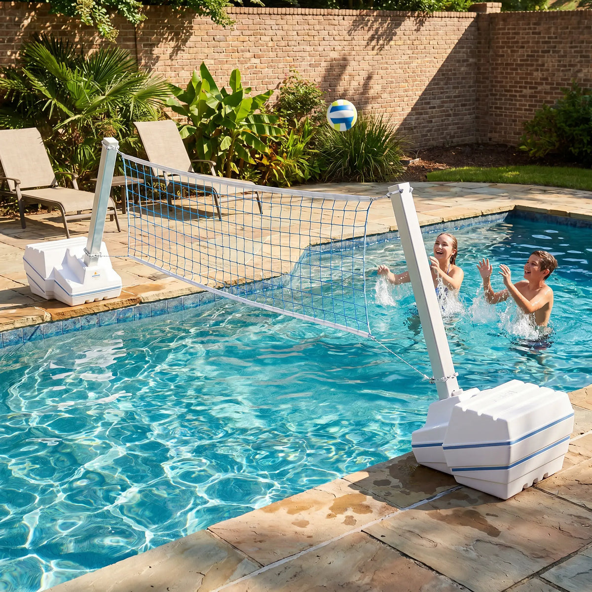 Kids playing with SlamVolley ball freestanding pool volleyball net while ball is being served.