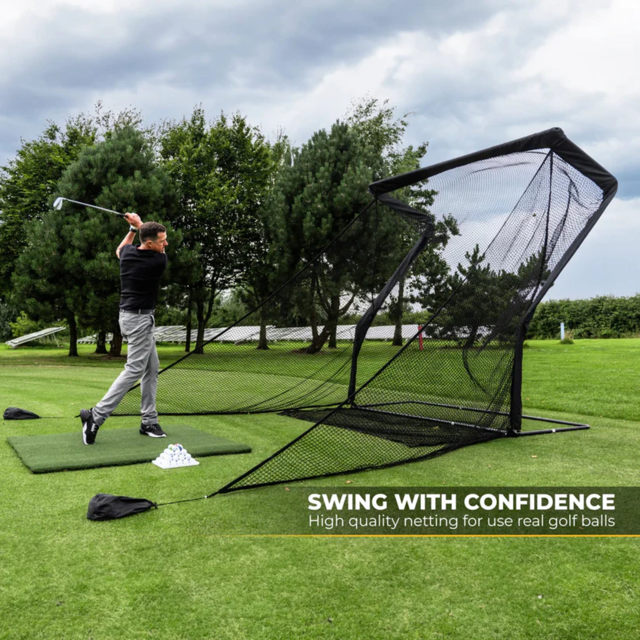 Golfer practicing confidently with SimSpace golf practice net and extended side barrier protection