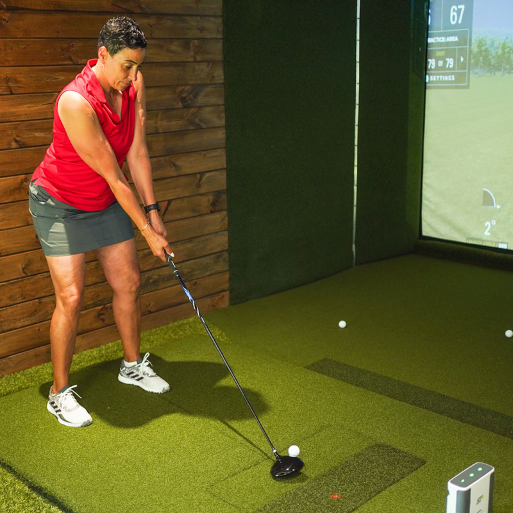 Golfer practicing on Real Feel Centerstrike golf mat with replaceable hitting insert technology