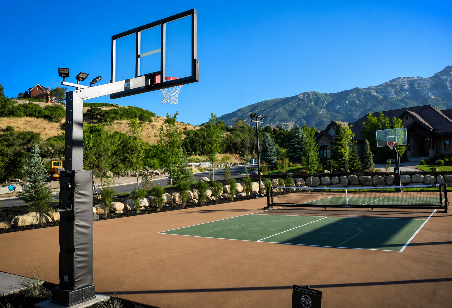 Sport court featuring Dominator basketball hoop and sport court light and pickleball net system