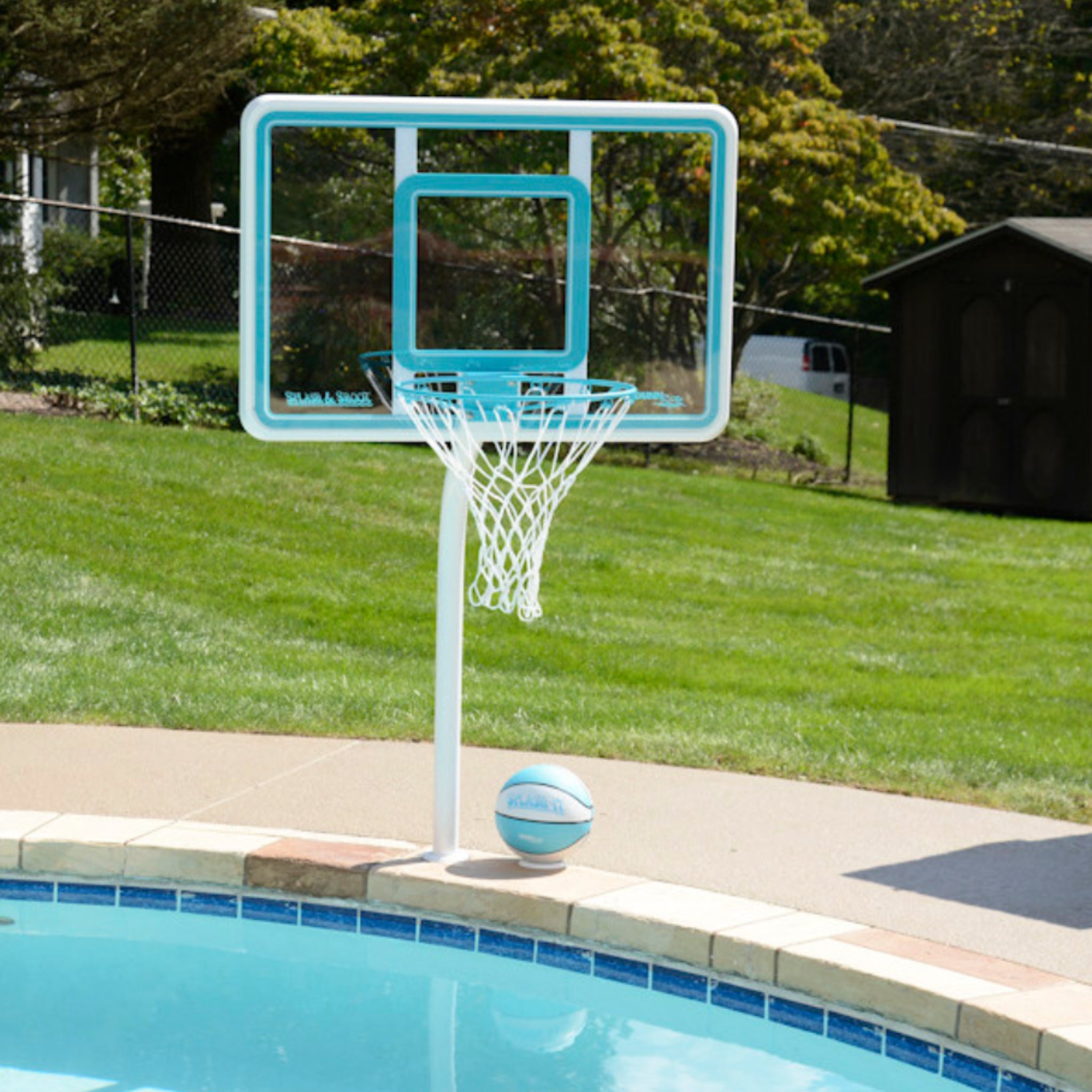 Poolside basketball hoop and volleyball net set designed for saltwater pools