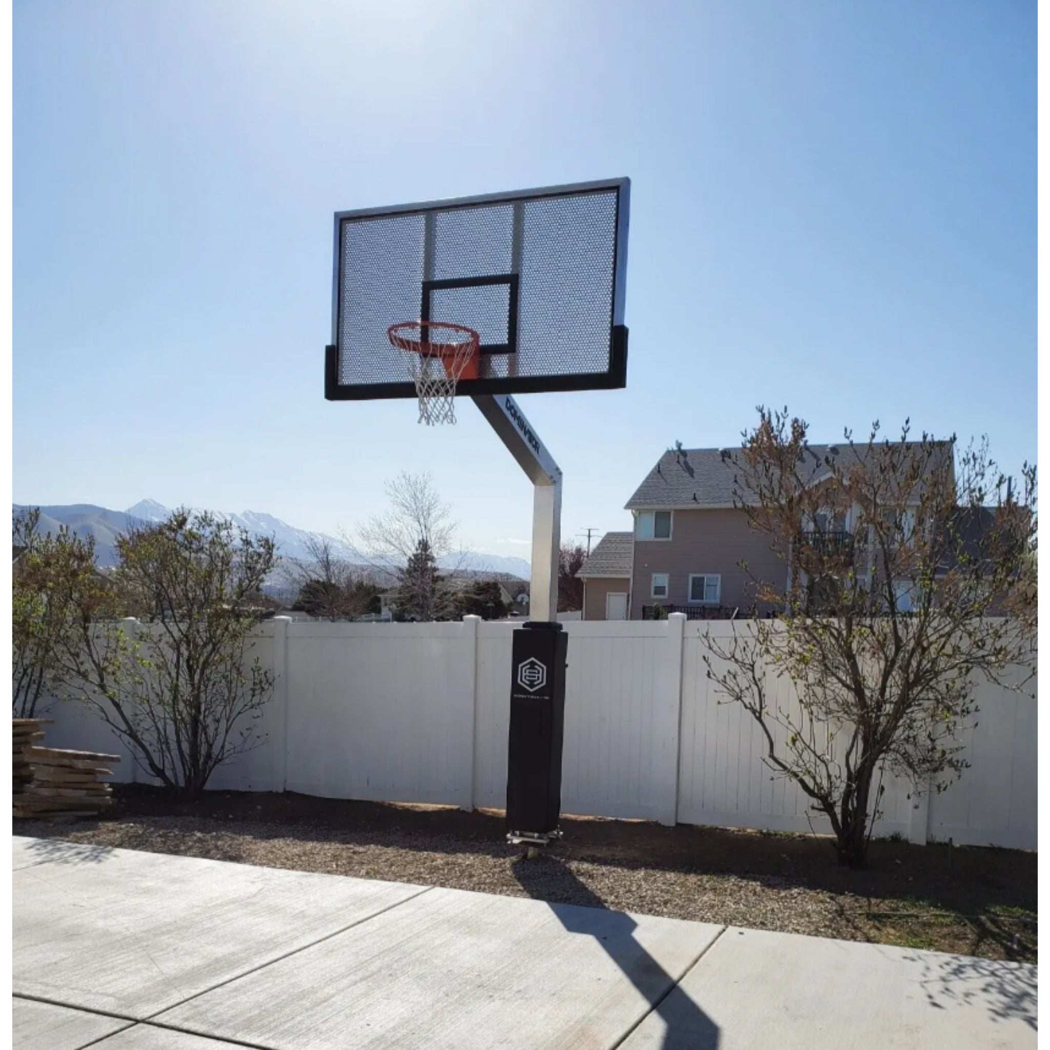 Surface mount Dominator Pro basketball hoop installed on outdoor court