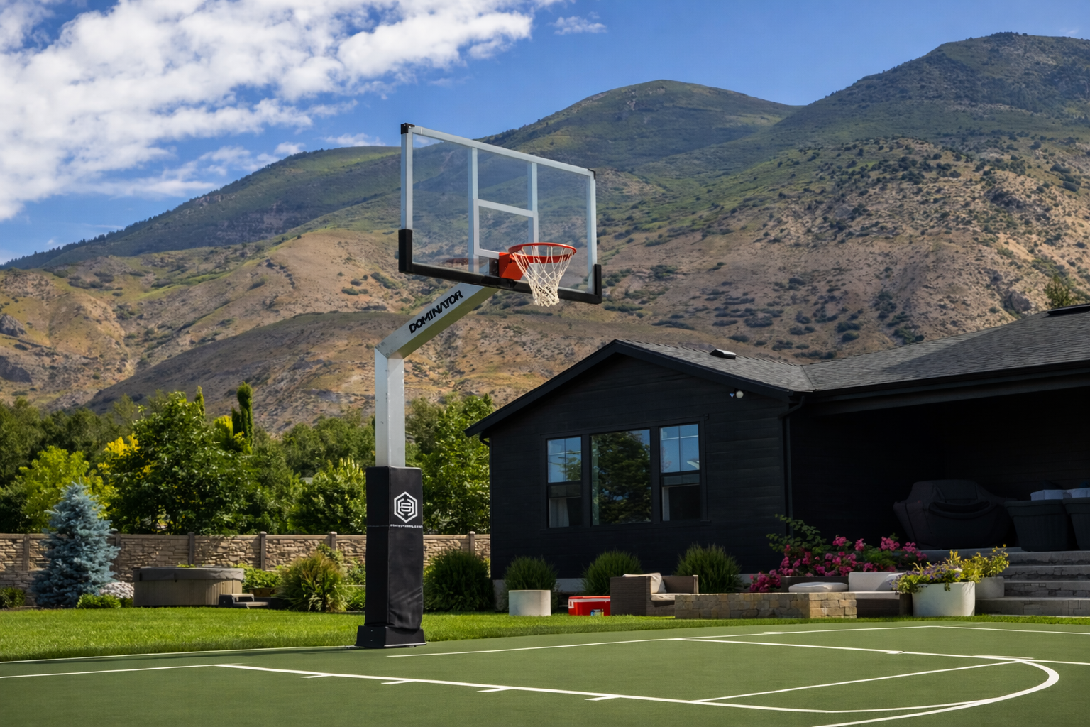 Dominator basketball hoop on sport court at luxury home with mountains