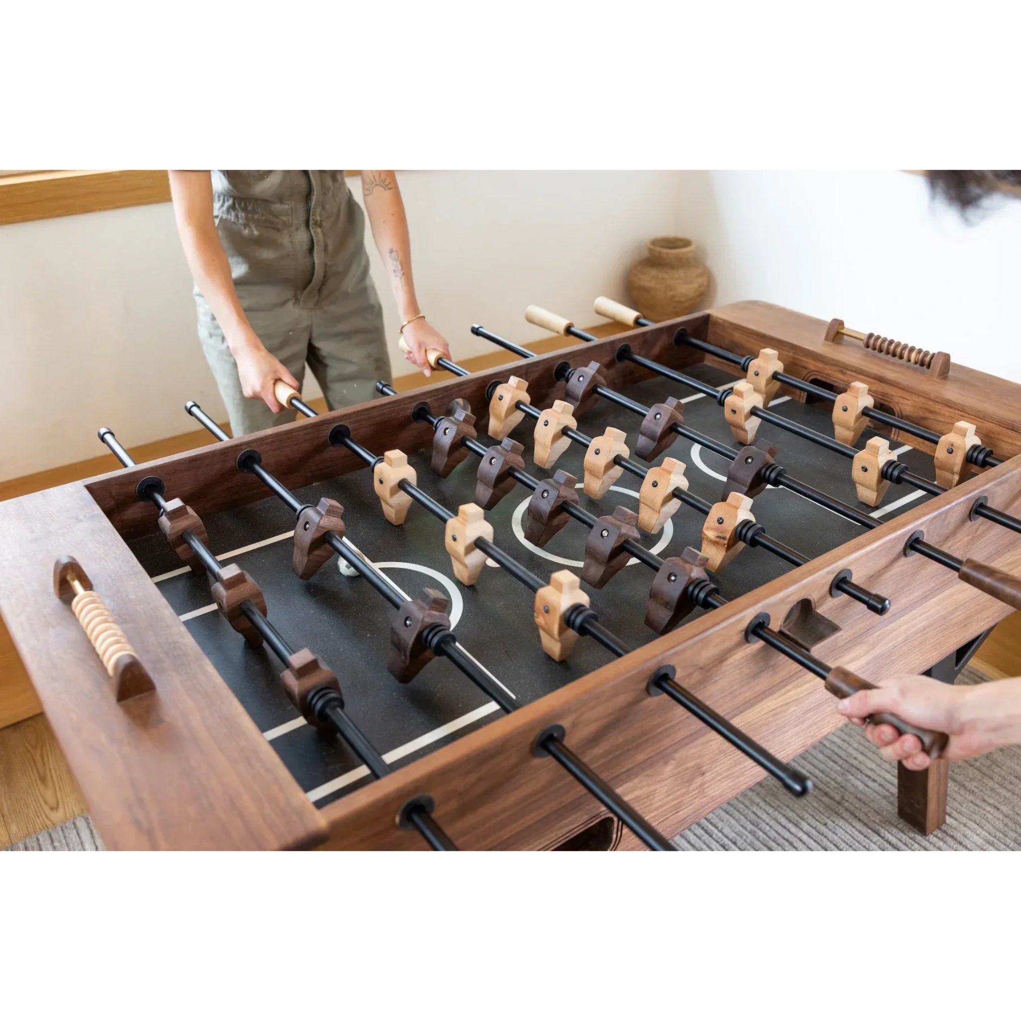 Luxury walnut foosball table with black steel base in modern living room