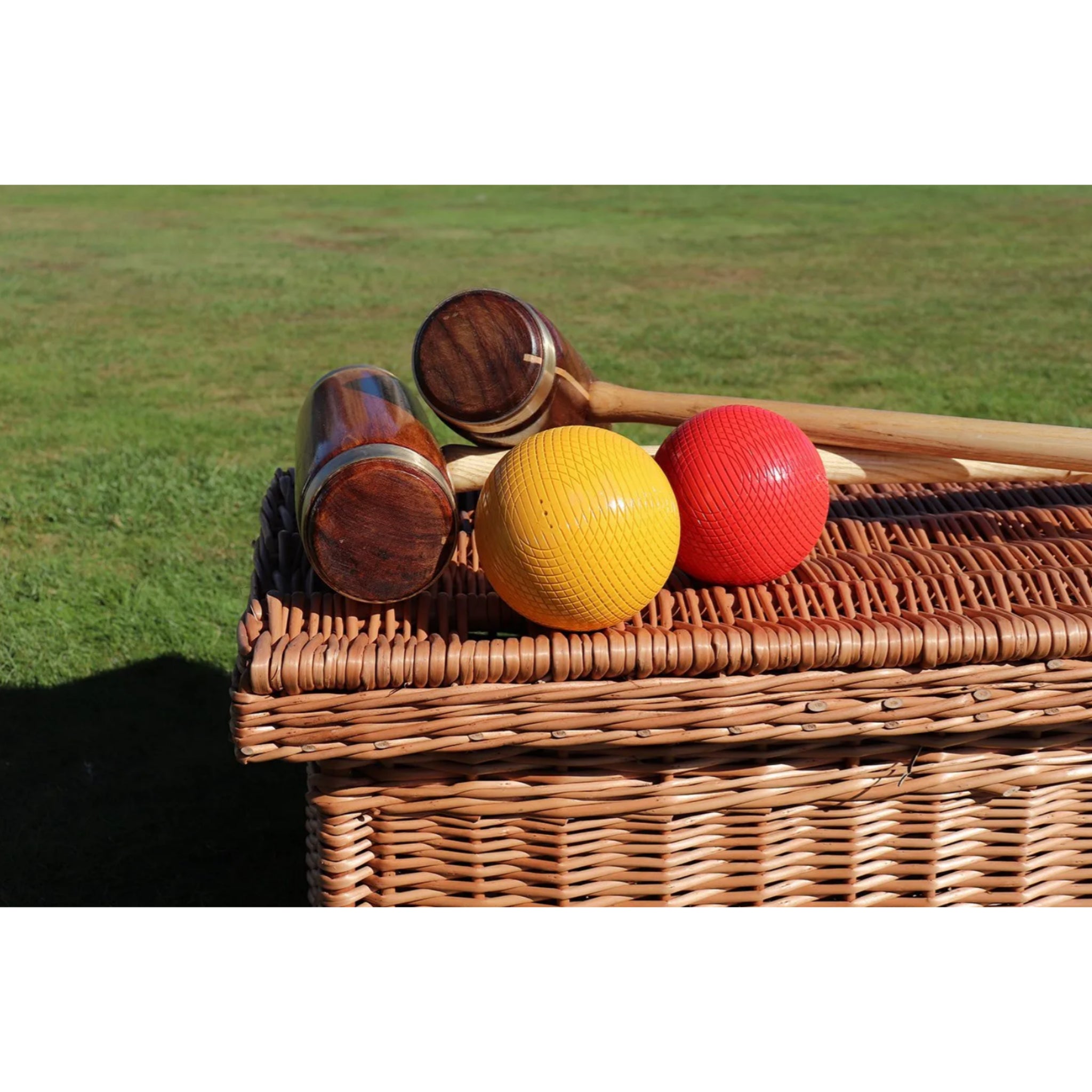 Four-player garden croquet set with brass-banded wooden mallets and accessories