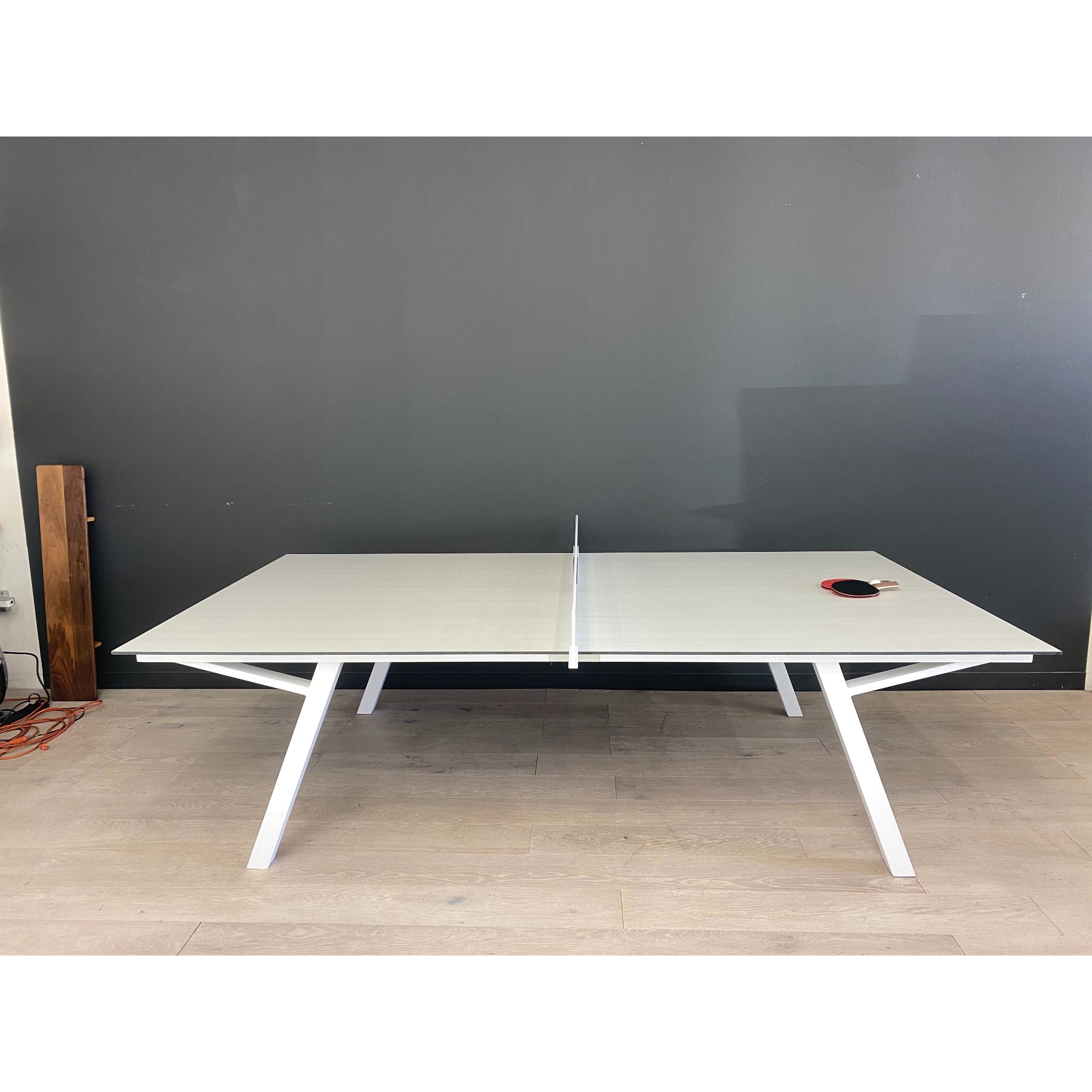 Luxury outdoor ping pong table by Sean Woolsey in a modern backyard patio, premium metal and formica table tennis design for upscale residential and hospitality spaces