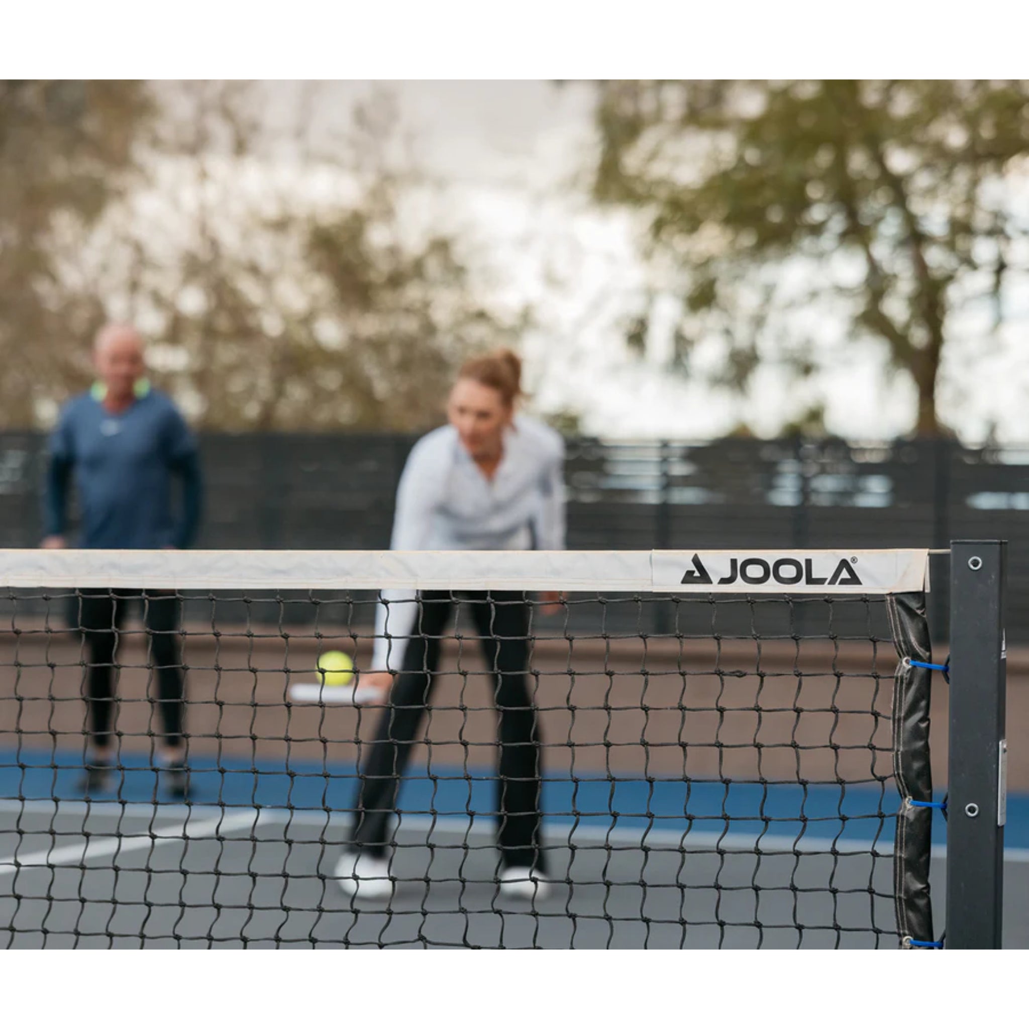 JOOLA pickleball net tensioning system with hand crank and steel cable for tight regulation net