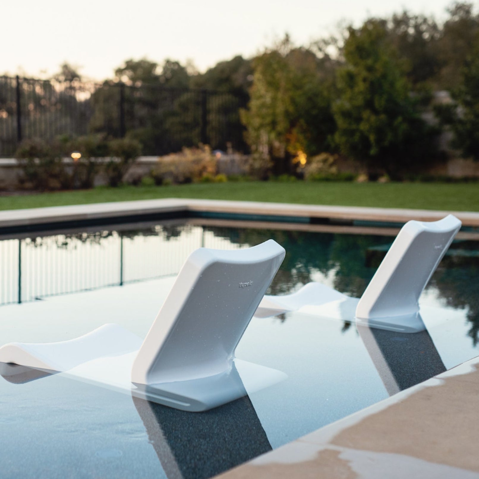 Line Lounge Chair two chairs in High Cloud White color sitting In-Pool
