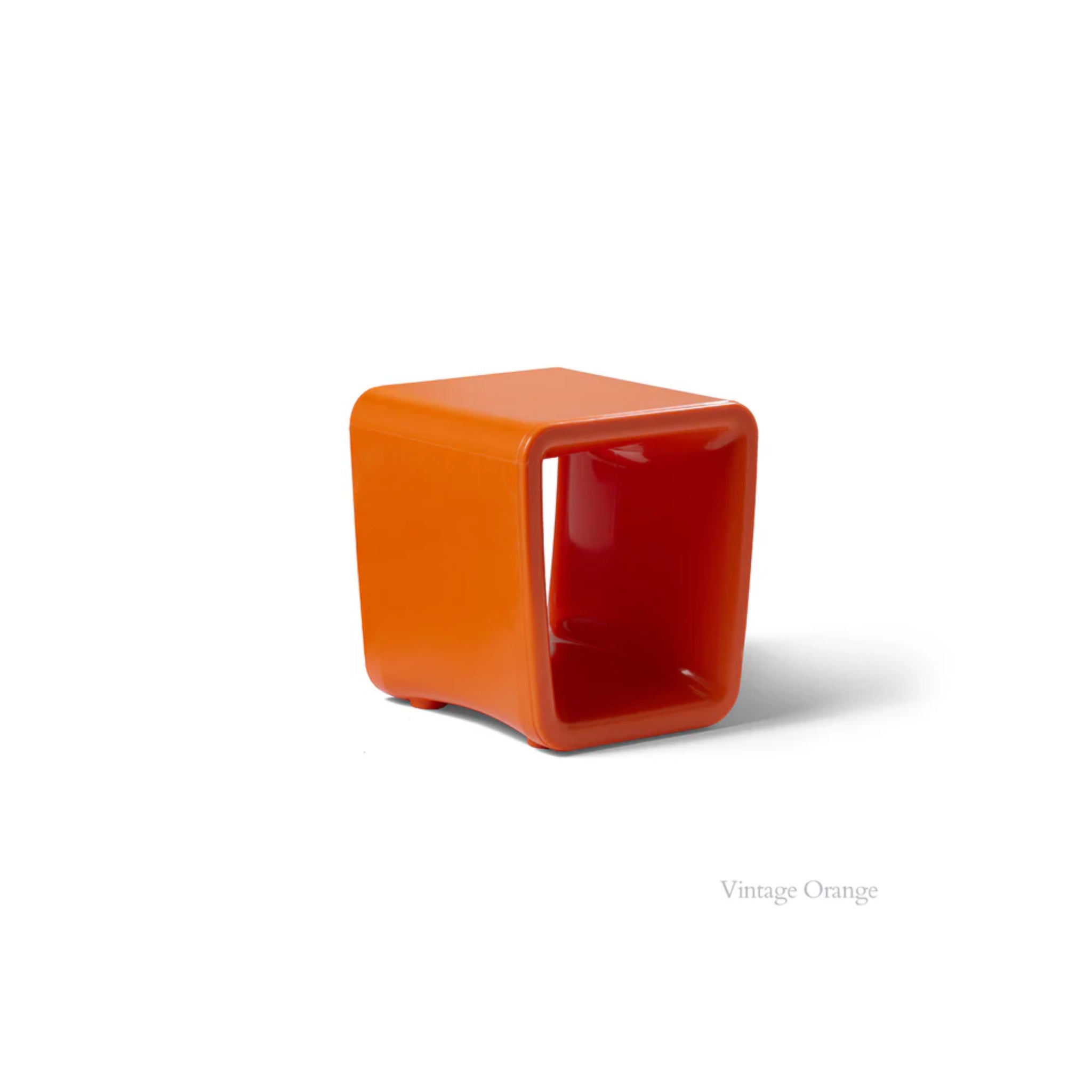 Loop Table in Vintage orange by tupelo is a cube-shaped stool for in-pool lounging
