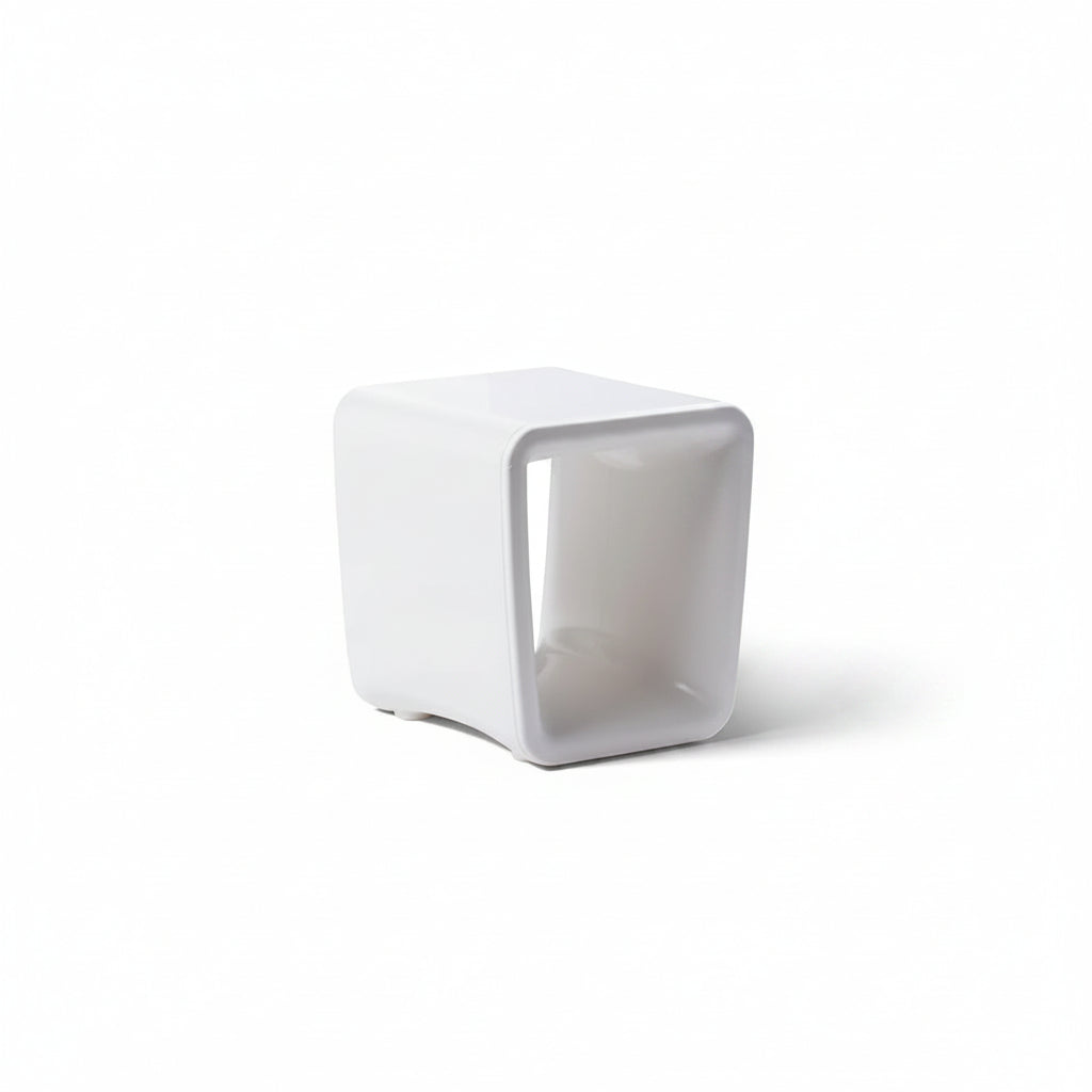 White cube-shaped side table on a white background