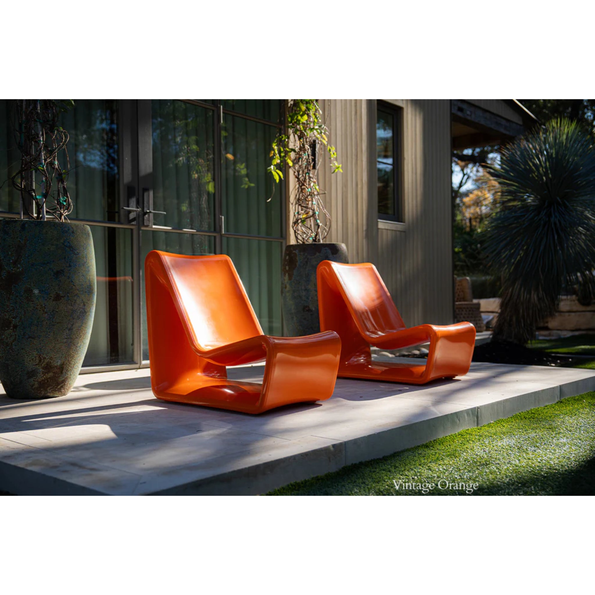 Orange outdoor lounge chair creating bold poolside seating in a modern backyard retreat
