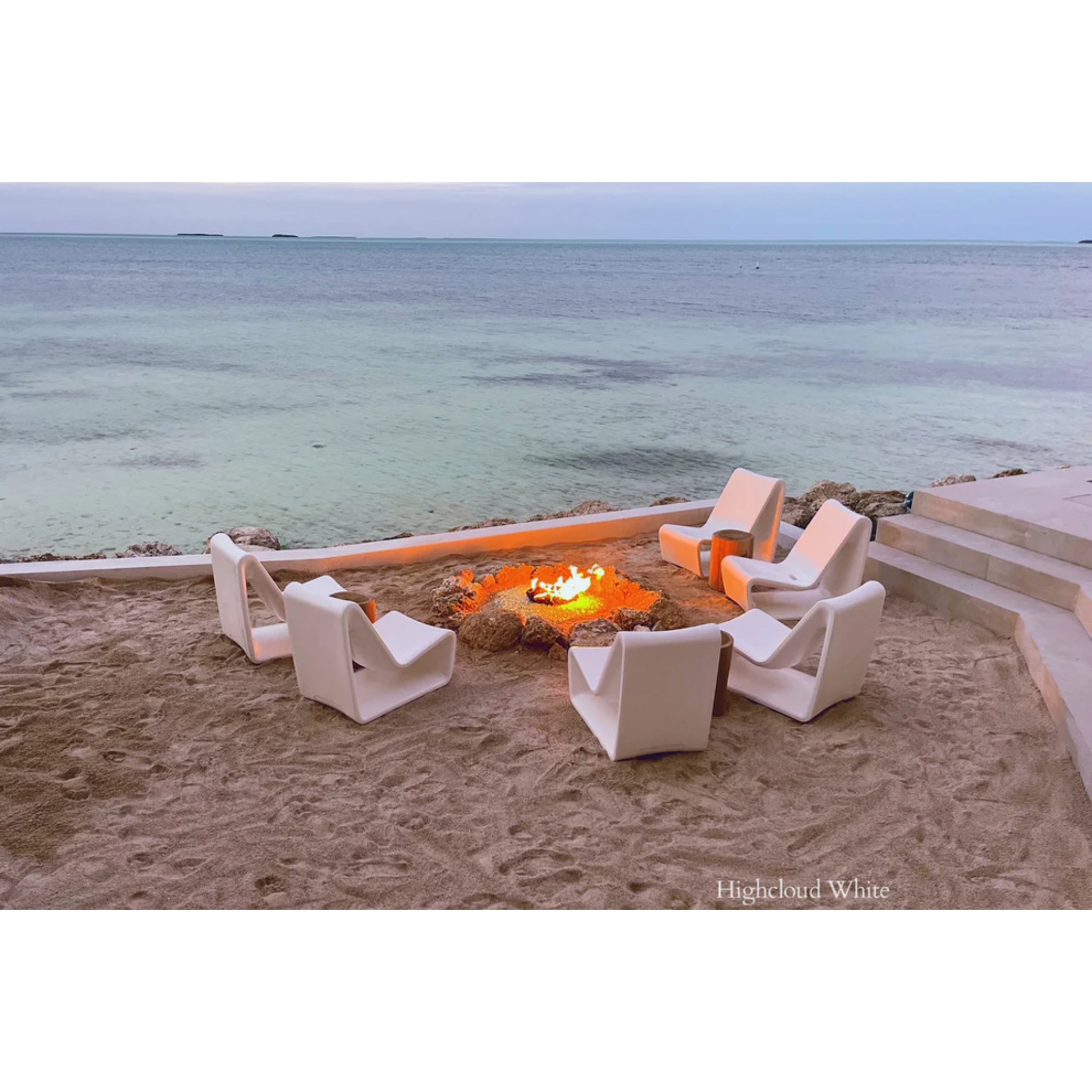 Luxury white outdoor lounge chair positioned on a baja shelf beside the ocean