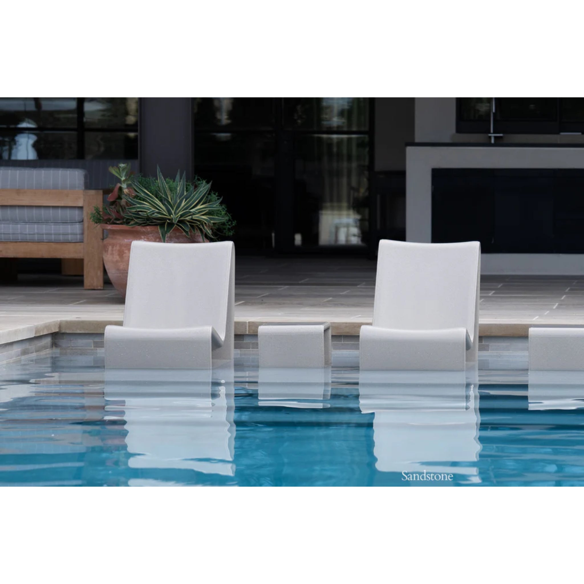 Loop in-pool side table creating a sophisticated resort-style gathering space