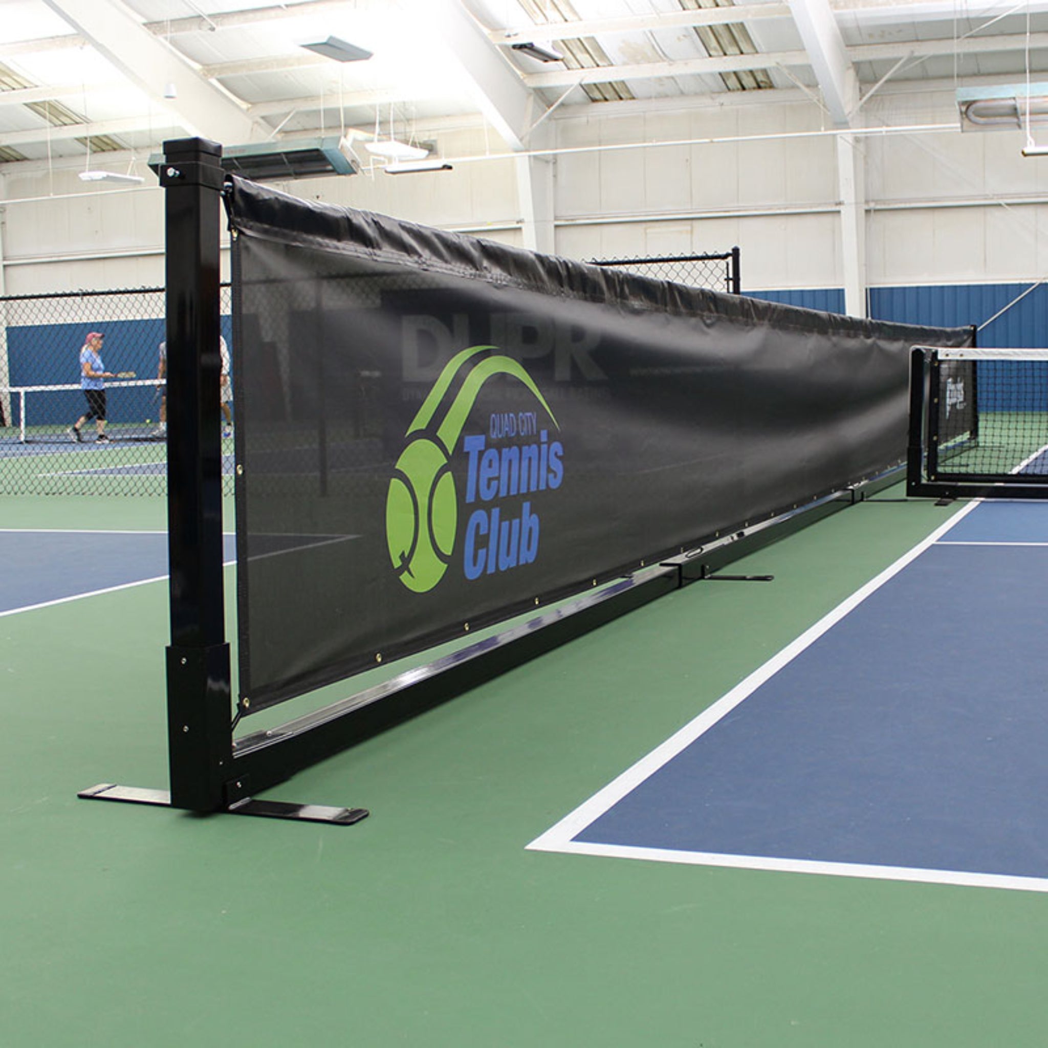 Close up of indoor pickleball divider with windscreen mesh panel and custom logo