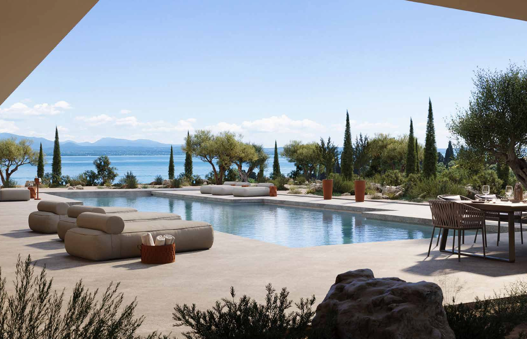 View of Pinetti leather accessories on patio with swimming pool next to lake.