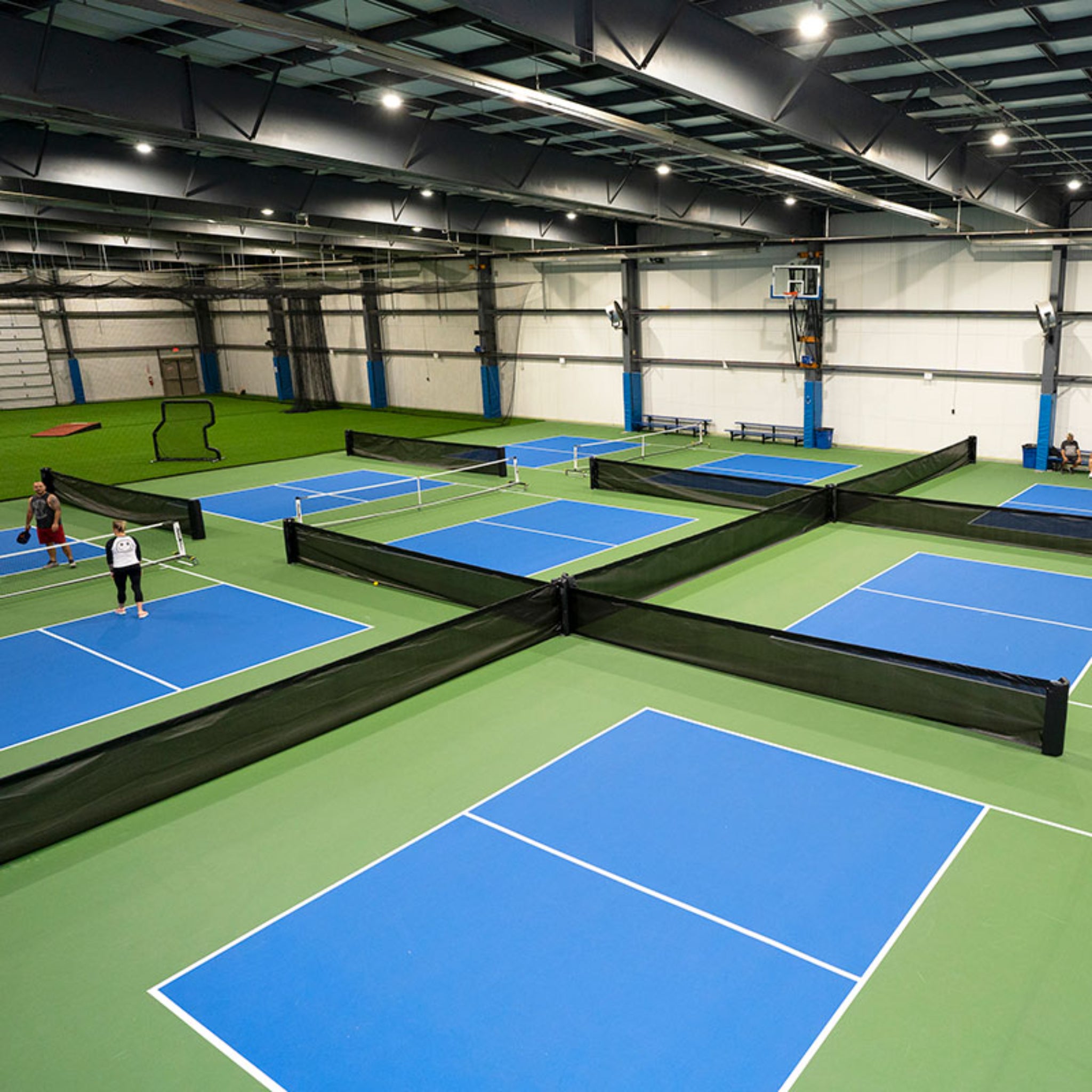 Surface mount pickleball court divider system for indoor or outdoor facility