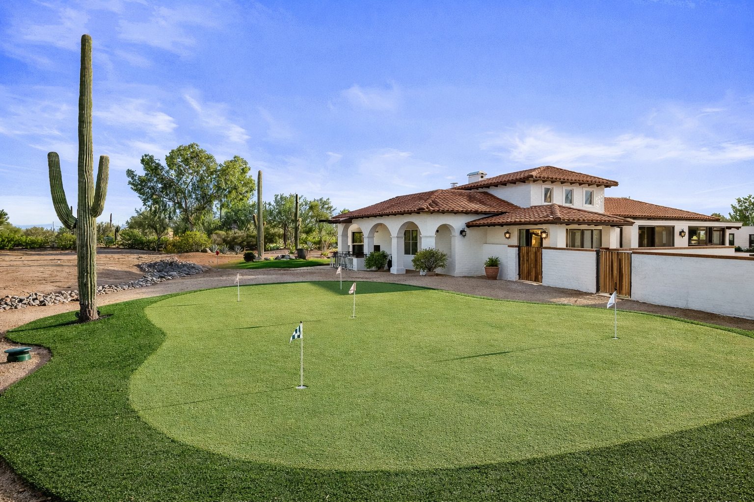 Santa Barbara style home with outdoor putting green