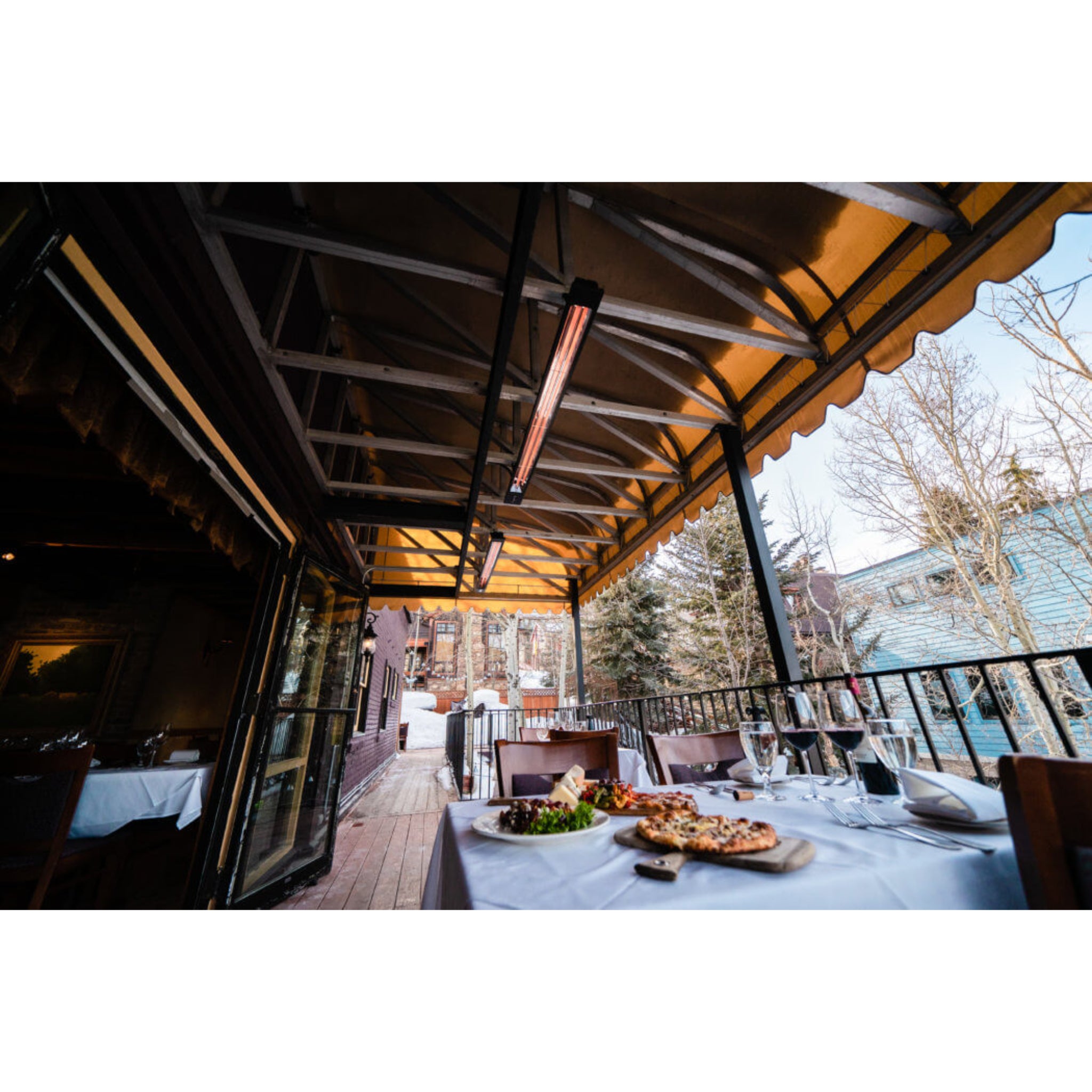 Infratech SL Series infrared heater  in black finish installed on ceiling of restaurant patio