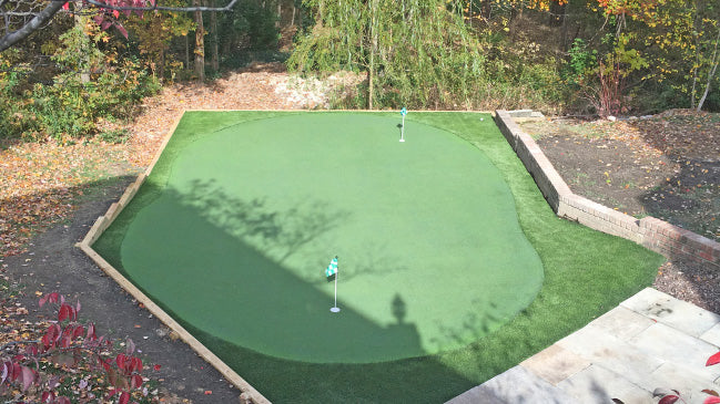 The DIY Carolina backyard outdoor putting green installed in a backyard.
