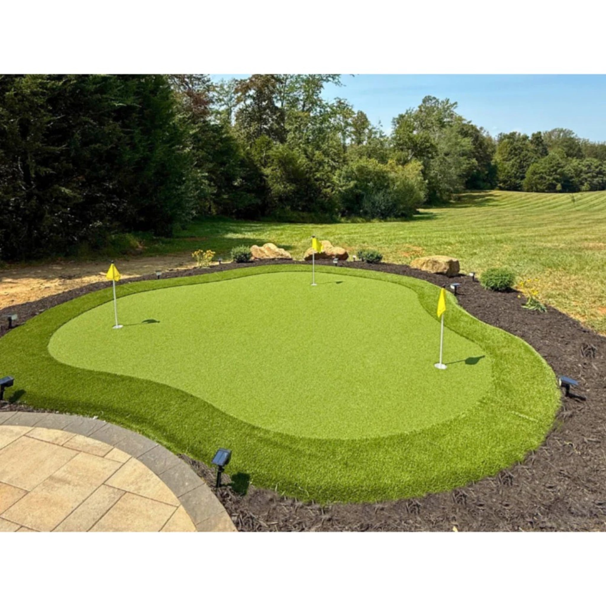 The Kiawah Outdoor Putting Green, DIY Kit 15 feet by 17 feet, 255 sq. ft. backyard installation next to open space.