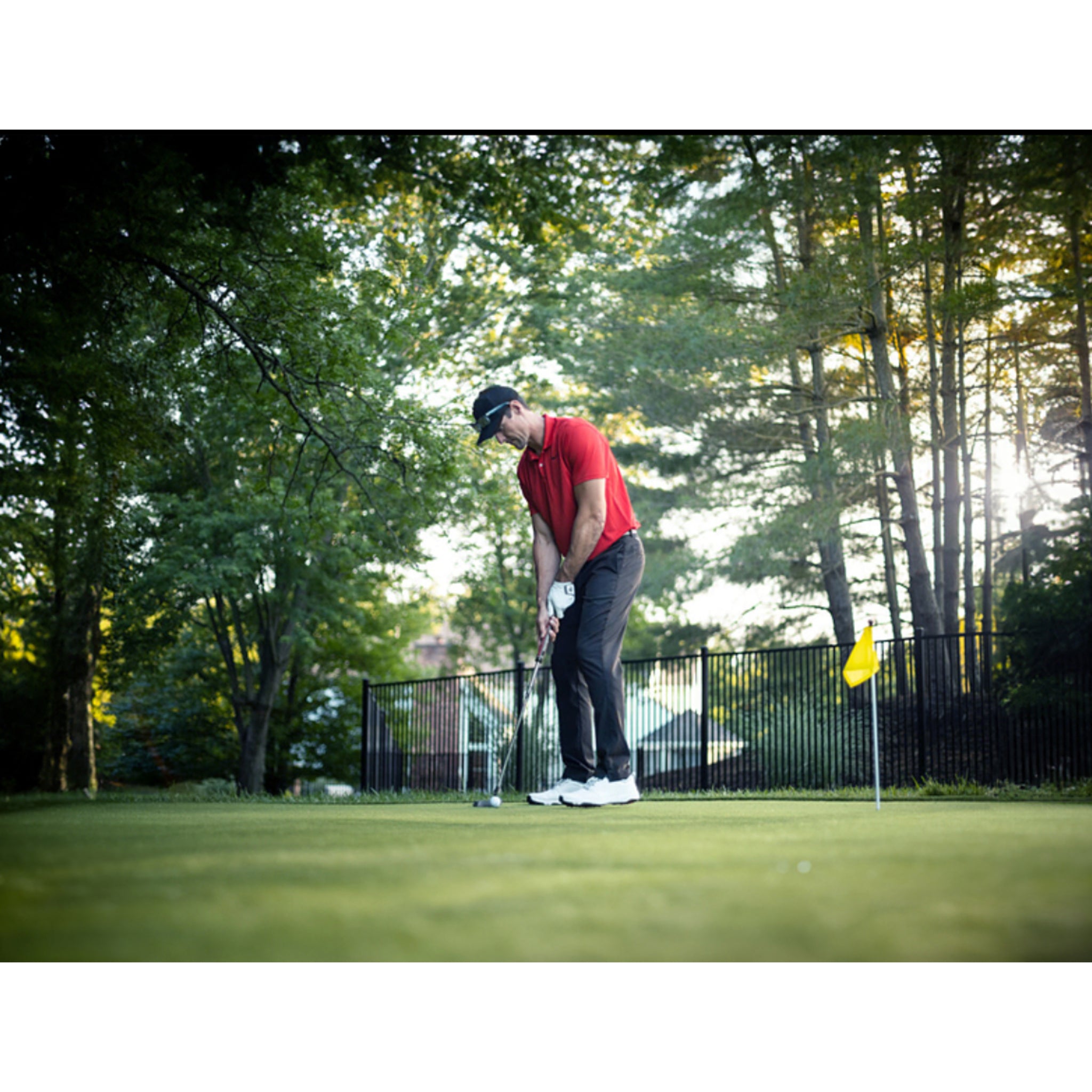 Ultra Base Outdoor Backyard putting green with golfer hitting ball.