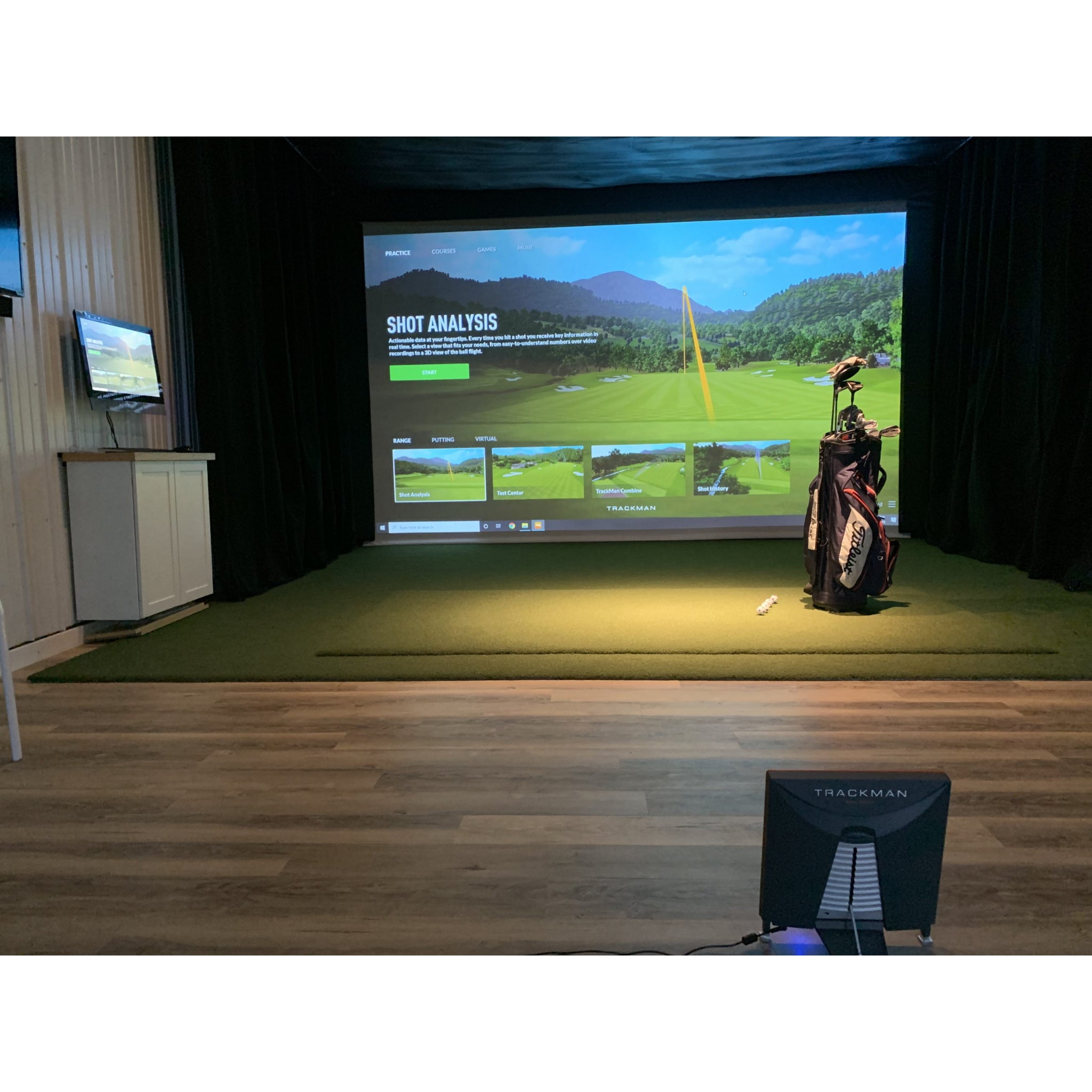 Golf simulator setup featuring Country Club Elite hitting mat