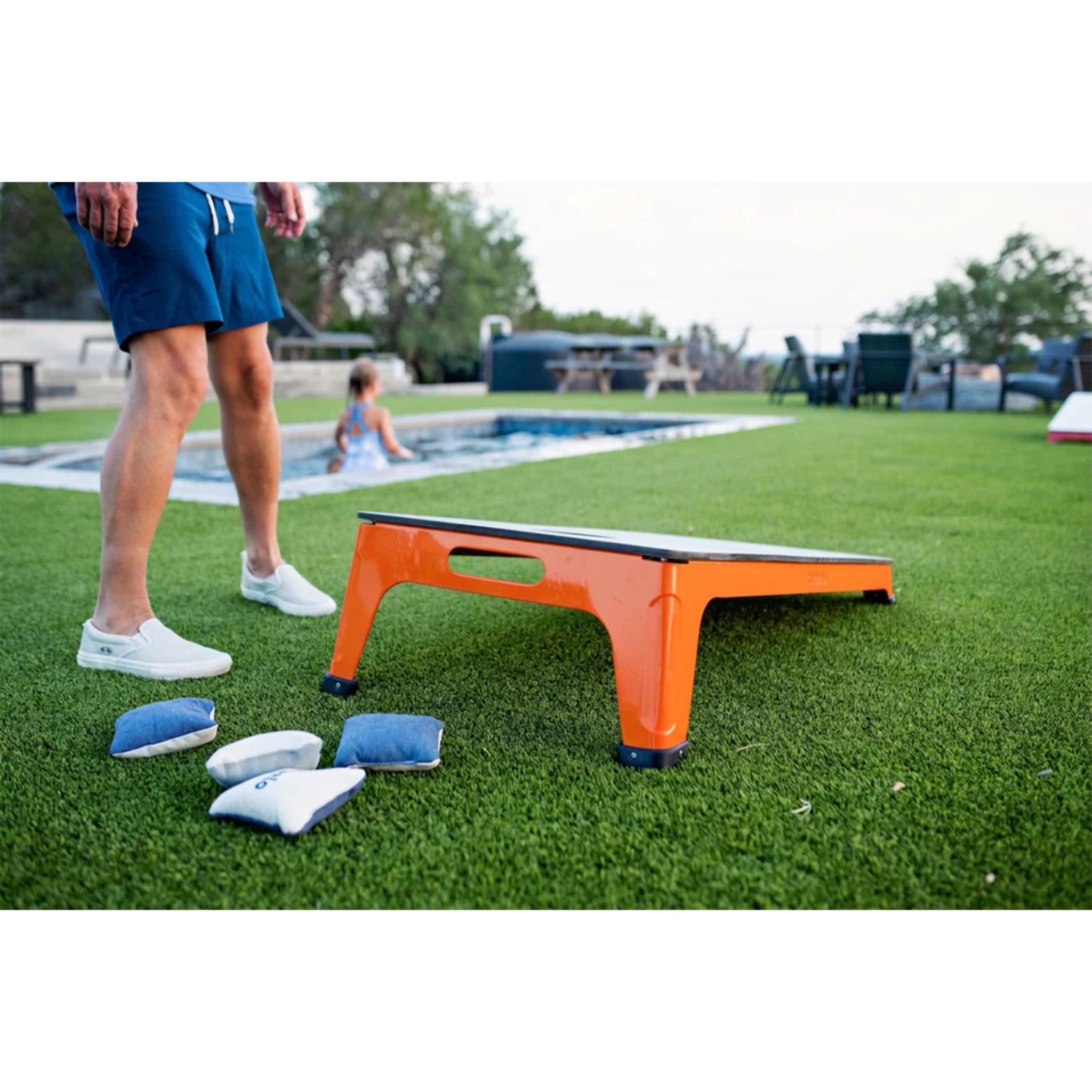 Luxury all-weather cornhole set displayed poolside with modern outdoor furniture for upscale residential and hospitality spaces