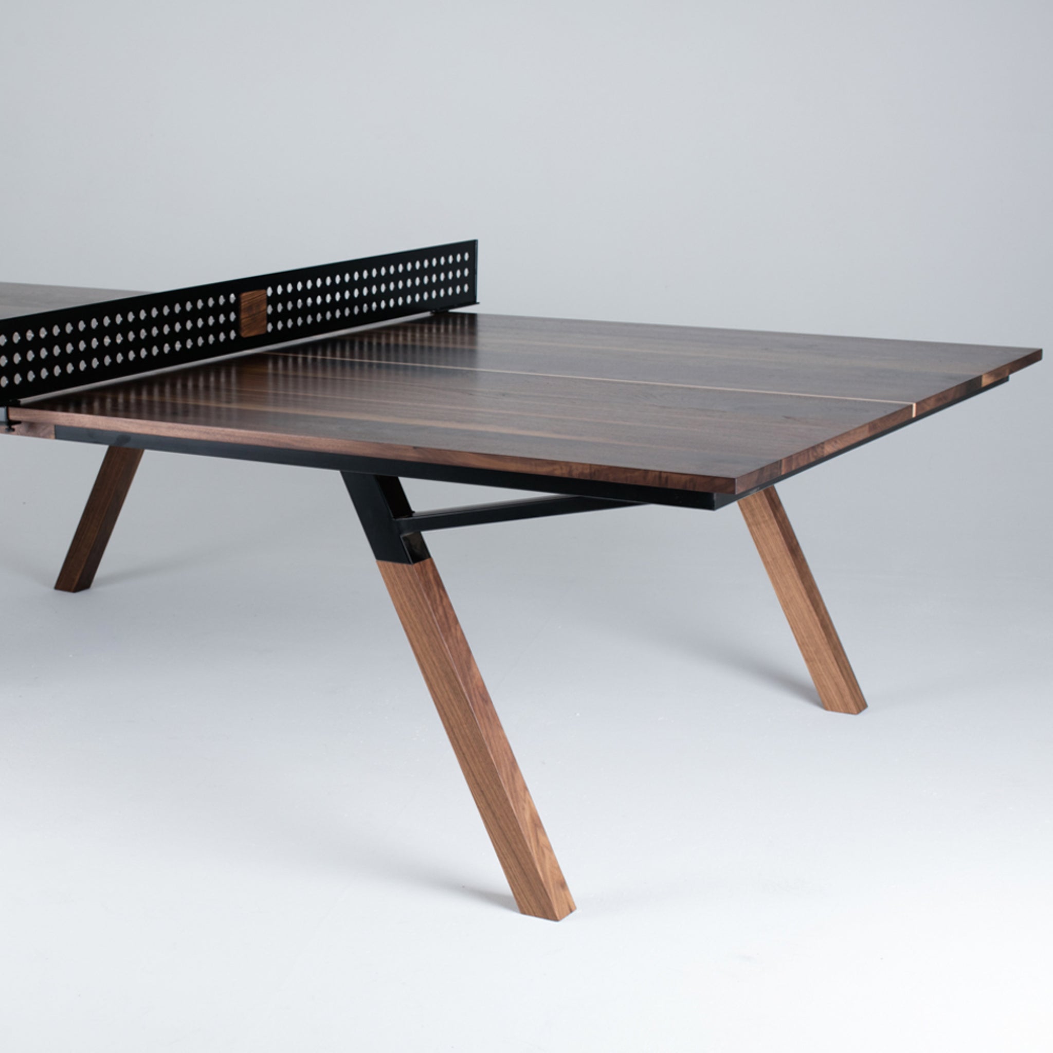 Woolsey indoor ping pong table in walnut wood with modern angled legs