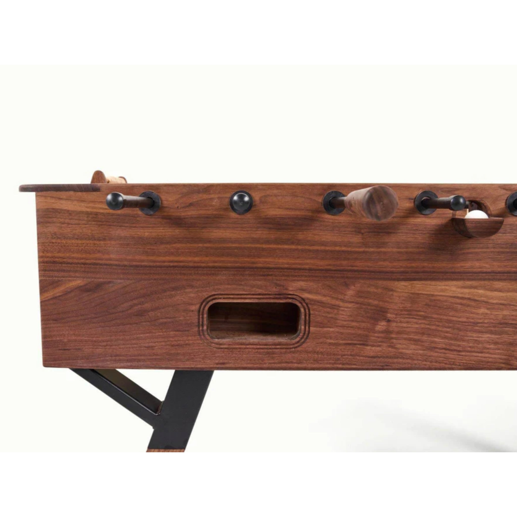 Close view of walnut foosball table cabinet and recessed ball return