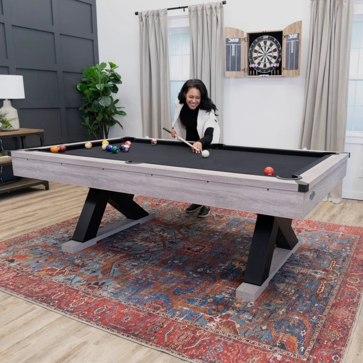 American Legend Kirkwood pool table in a stylish residential game room with billiard cues and balls