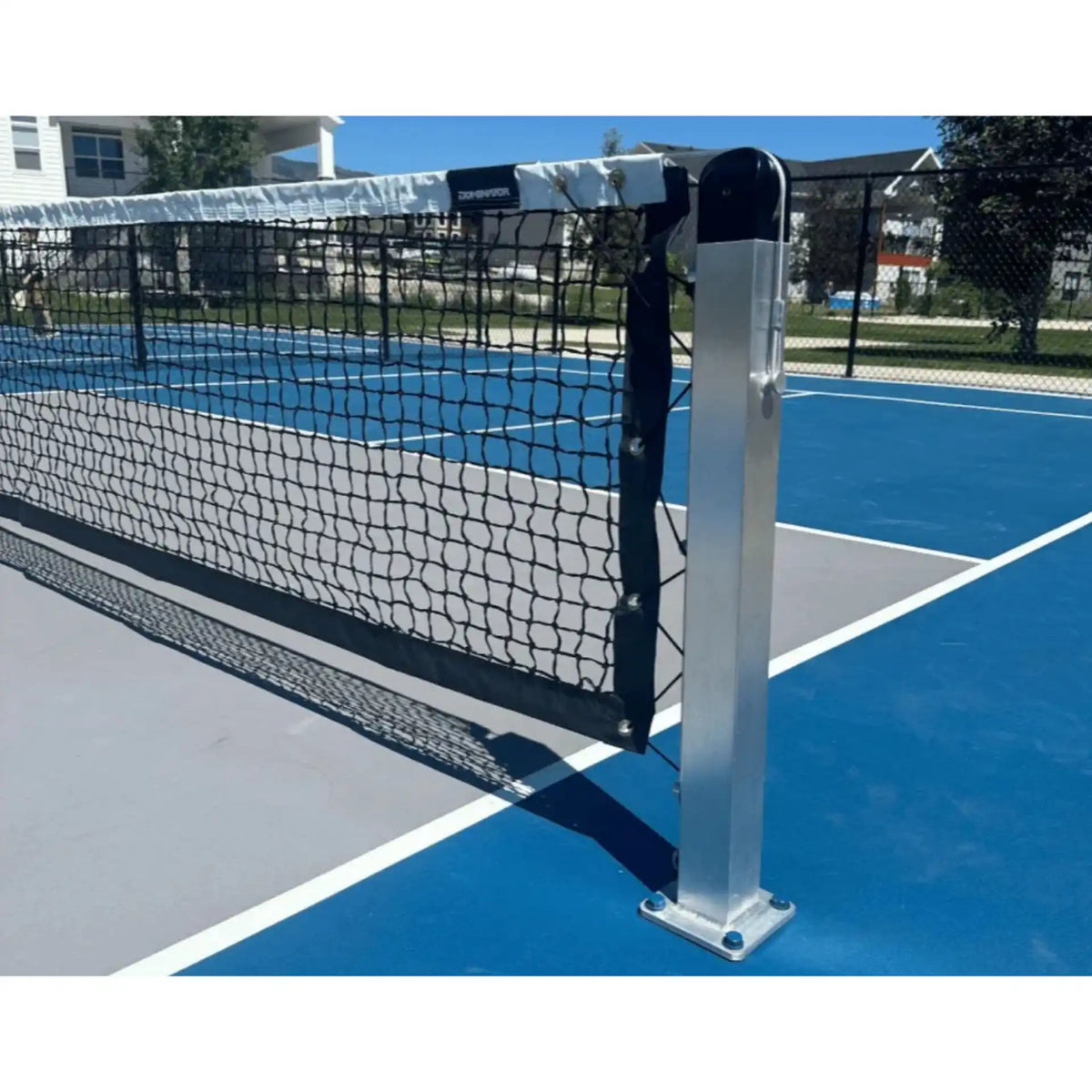 Dominator in ground Pickleball Net & Posts System in silver aluminum installed on an outdoor concrete pickleball court with adjustable net tension, SKU SPB-SM2.